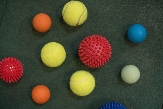 self massage and reflexology therapy concept - a set of small rubber balls and roller bar