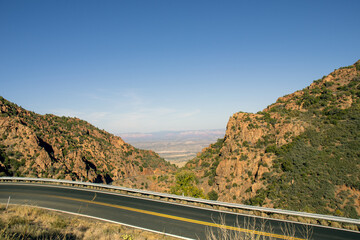 Fototapeta na wymiar Highway 89A above Jerome, looking down on the Verde Valley and in the distance, the Red Rocks of Sedona.
