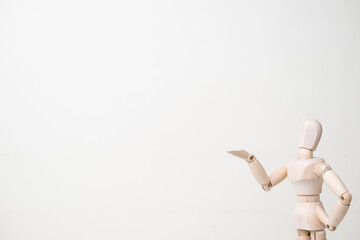 wooden mannequin with doubtful gesture on white background - confusion and asking question concept