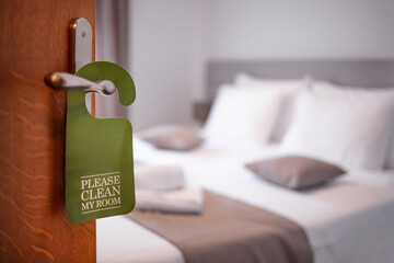 Please make up my room. Maid cleaning the room with please make up my room sign on the door. Opened...
