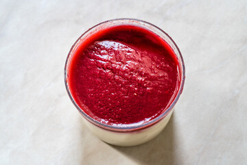 Delicious Italian Dessert Raspberry Panna Cotta with Berry Sauce.