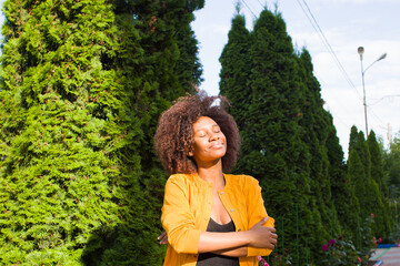 Naklejka premium A happy and young African American woman walks down the street