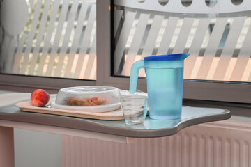 Food on a mobile tray in a hospital ward