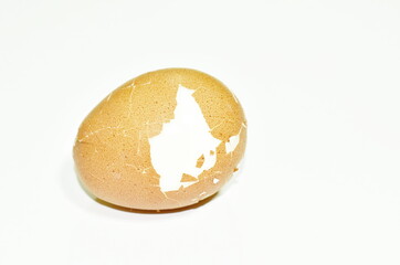boiled egg cracked shell out on white background