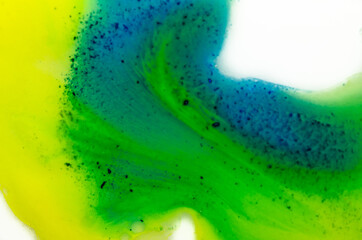 Liquid bright aquarel colours with oil generate fluid structures and bubbles in green, blue, yellow, white and gold