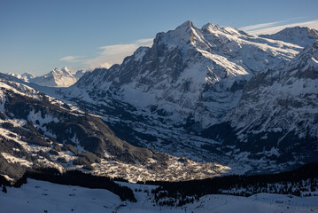 Fototapeta premium View of the Swiss mountains in winter. Mittelhornin clouds, Schreckhorn and Wetterhorn. Swiss alps in Switzerland Jungfrauregion