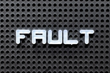 White color alphabet with word fault on black pegboard background