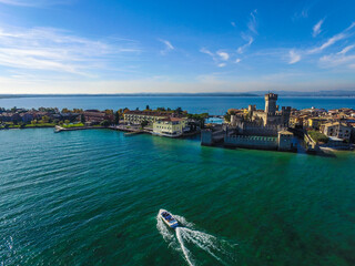 motorboat sails towards Rocca Scaligera Castle in Sirmione.
Garda Lake - Italy view by Drone