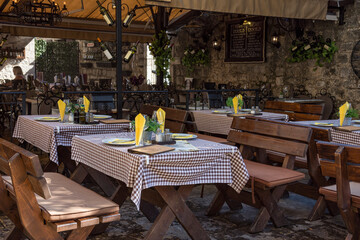 Cose, italian style restaurant's garden. Wooden benches. Pizzeria. Lifestyle concept