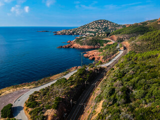 Fototapeta na wymiar Aerial view by Drone in Saint-Raphaël near Agay on c like to be in USA. Roches Rouges by the mediterranean sea. Toursim in Côte d'Azur, sud France. Blue water and rocks.