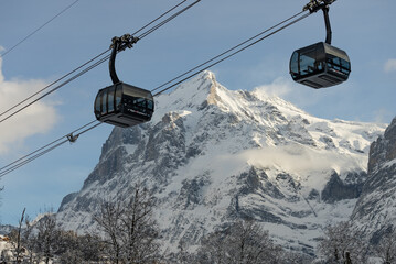 View of the Swiss mountains in winter. Mittelhornin clouds, Schreckhorn and Wetterhorn. Swiss alps in Switzerland Jungfrauregion