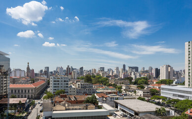 Beautiful view of S&atilde;o Paulo city skyline, avenues, houses and downtown business buildings in the background on sunny summer day with blue sky. Concept of urban, travel, latin america, tourism.