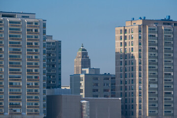 Fototapeta na wymiar A view of a modern city district with grey concrete buildings.