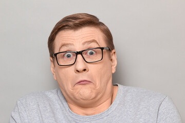 Portrait of confused surprised mature man with glasses