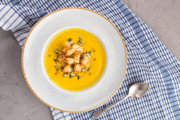 Homemade Autumn Butternut Squash Soup with Bread and seeds on the table
