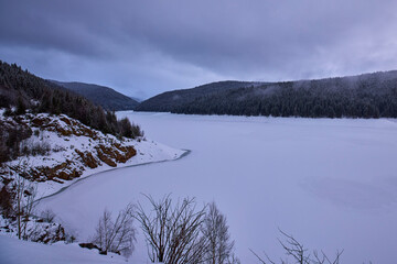 landscape with a lake in the mountains in winter