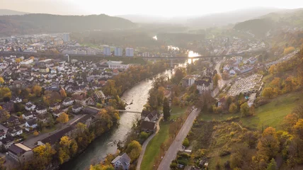 Poster Drone view of city Brugg south-west and Umiken with Aare river, residential districts, bridge and old mill, famous train viaduct in canton Aargau in Switzerland. Town situated on feet of Tafeljura. © Claudine