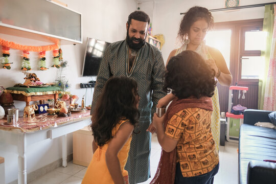 Indian Family Celebrate Hindu Event At Home - Traditional Dress And Religious Celebration - Parents And Children
