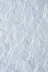 Fresh clean white snow background texture. Winter background with snowflakes and snow mounds. Snow lumps. Seasonal landscape details.