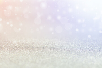 Silver background, bokeh with colored highlights.
