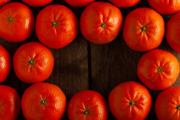 Fresh tangerines on a wooden table with copy space.