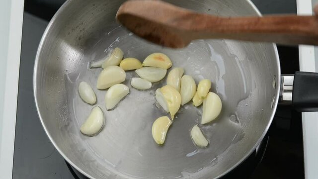 Frying garlic with oil in a saucepan