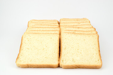 Pieces of wheat toast bread laid out in two rows on a light background