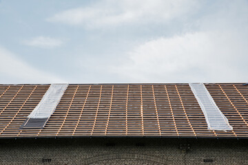 Unfinished roof works. Building a new roof of the house. Detail view of the wooden planks on the roof.