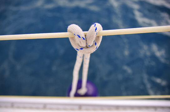 Nautical knot close up. Sailing concept. Hanging fender of the sailing boat