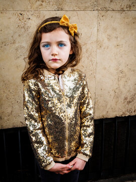 Portrait of a girl wearing a gold sequin jacket