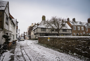 Snow on cobbled square, Rye, East Sussex, England