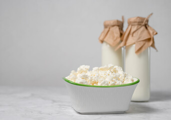 Bottles with fresh milk and cottage cheese. dairy products are a source of calcium and protein