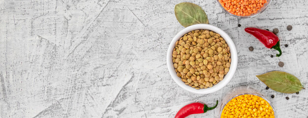 Three varieties of lentils photographed from above. Lentils in white plate on white stone background. Vegetarian super food. Top view with copy space. Flat lay.
