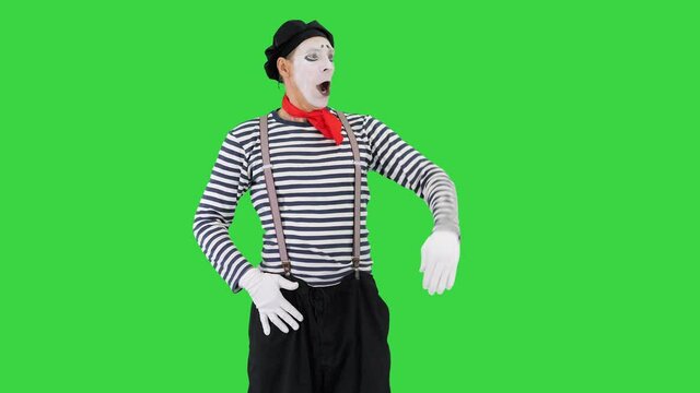 Man dressed like mime looking far away on a Green Screen, Chroma Key.