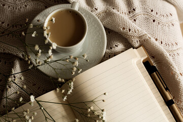 Hygge life style concept: cup of coffee and note book