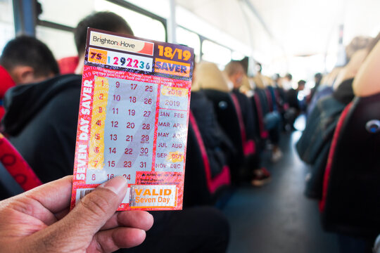 Brighton, England-1 October,2018: Student or tourism holding the Brighton&Hove seven day saver bus pass ticket inside the public bus route.