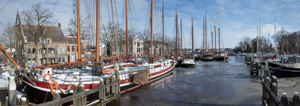Historic wooden ships. Harbour of Zwartsluis Netherlands. Bruine vloot. Brown fleet.  Winter. Panorama.