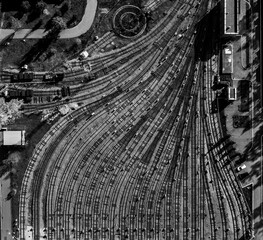 aerial creative top view to metro depot heavy rail, subway, tube, metropolitana or underground. Black and white square design composition. Abstract representation of public transport industry in art