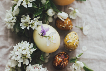 Obraz na płótnie Canvas Happy Easter! Easter rustic flat lay with eggs and spring flowers on linen. Aesthetic holiday