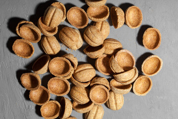 Homemade cookies nuts with condensed milk on a wooden table. Empty halves for filling