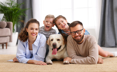 happy family playing with their favorite pet dog   at home