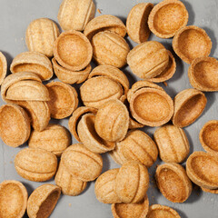 Homemade cookies nuts with condensed milk on wooden table. Pile of cookies in walnut form.