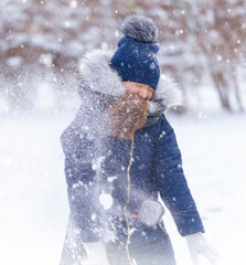 child girl playing with snow in winter outdoor and having fun on snowy winter