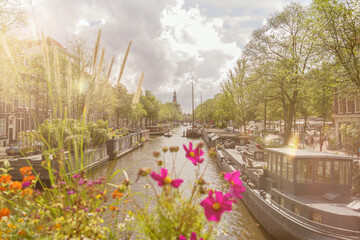 Sunny sightseeing view over a Amsterdam Amstel canal.  Travel, tourism and city concept.