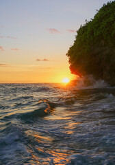 Fototapeta na wymiar Chasing sunsets on the wavy beach