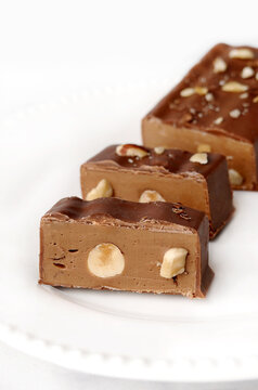 Close-up of a chocolate, hazelnut and nougat candy bar slices on a plate