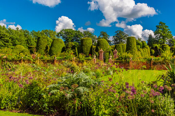 Fototapeta na wymiar A view across a mature garden beside a lake in Warwickshire, UK