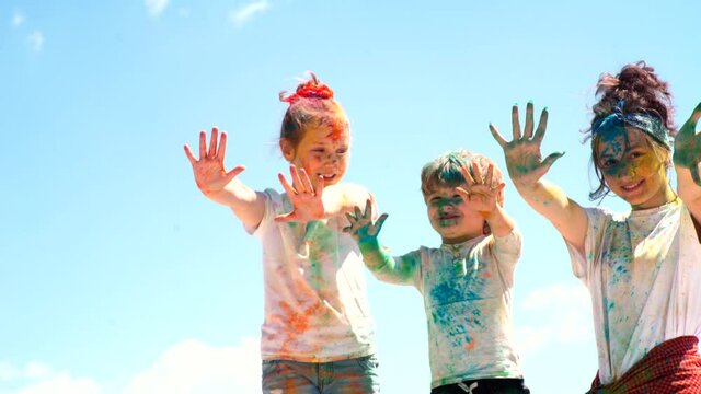 Happy childhood. Kids holi festival. Children playing with color powder.