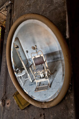 November 2020, Italy. Old dental chair reflected in a mirror of an abandoned dental office in Northern Italy. Urbex in Italy