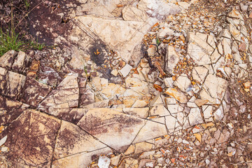 Sedimentary rock. Sedimentary rocks broken on pieces on the ground.